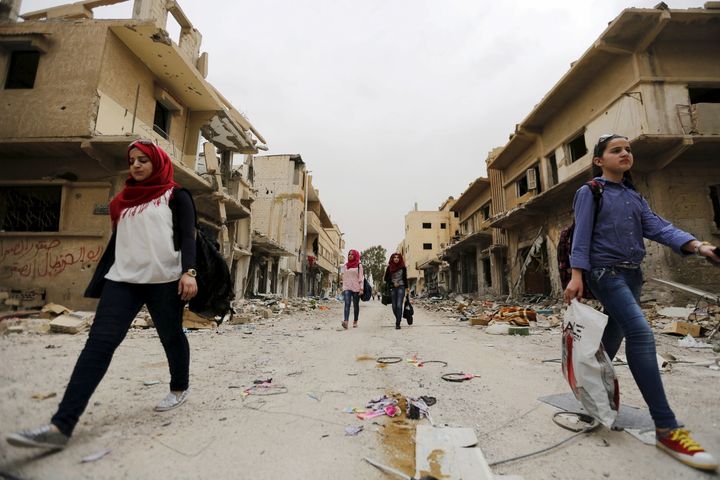 More and more women are at the forefront of efforts to solve local problems and to counter the violence in Syria. Above, women carry their belongings from damaged homes in the Syrian city of Palmyra.