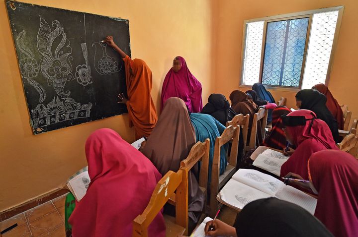 Ifrah Ahmed, a former Somali refugee and FGM victim, is now campaigning for the eradication of the practice. Young women attend an art lesson at a center that provides support for sexual violence victims in Mogadishu.