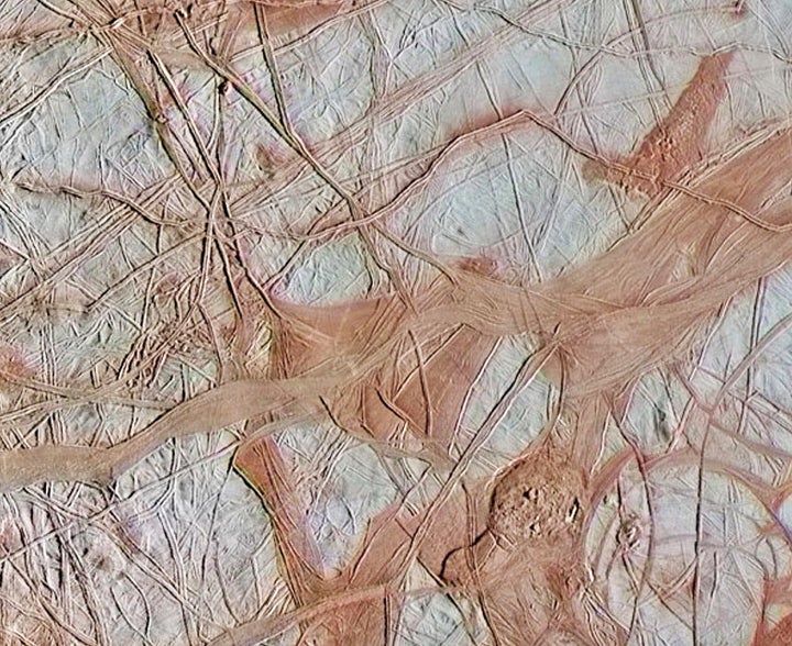 This is an enhanced-color view from NASA's Galileo spacecraft showing an intricate pattern of linear fractures on the icy surface of Europa in 1998.