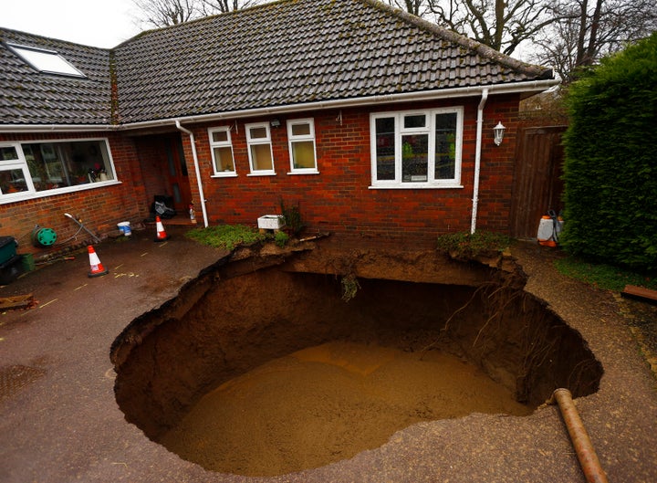 A 4.5 metre (15 feet) wide sinkhole at the driveway of a house in Walters Ash, southern England February 6, 2014. The hole swallowed a car which was not recovered.