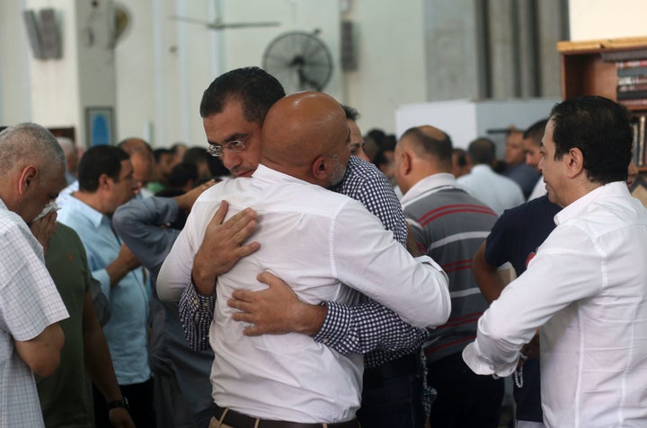 Relatives and friends of passengers of the EgyptAir plane that crashed in the Mediterranean, comfort each other during prayers at Abou Bakr el-Sedek mosque in Cairo.