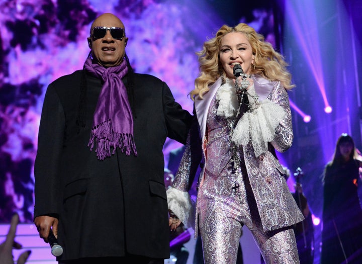 Stevie Wonder and Madonna perform a tribute to Prince onstage during the 2016 Billboard Music Awards.