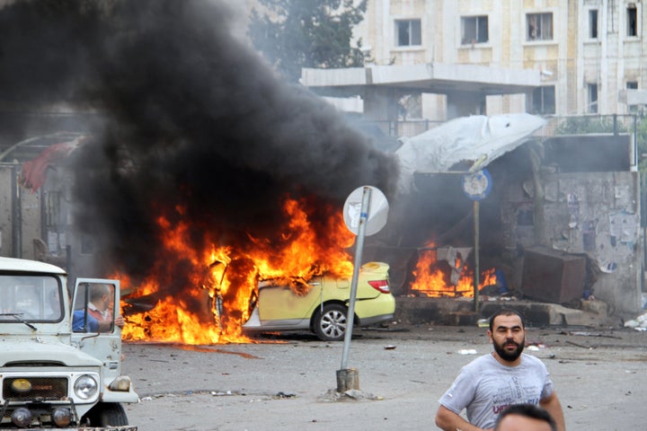 People inspect the damage after explosions hit the Syrian city of Tartous, in this handout picture provided by SANA on May 23, 2016