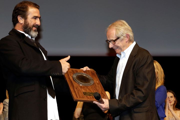 British film and television director Ken Loach, right, receives the Lumiere Award from the hands of former French football player and actor Eric Cantona, left, during the 4th edition of the Lumiere festival, in Lyon, central France, in October 2012