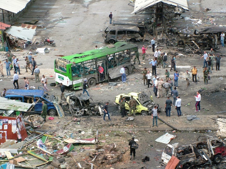 Syrian army soldiers and civilians inspect the damage after explosions hit the Syrian city of Tartous, in this handout picture provided by SANA on May 23, 2016.