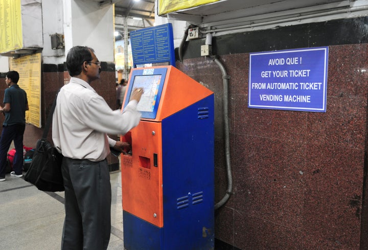 A passenger uses a touch-screen kiosk to buy a train ticket. The new child helpline kiosks will also be touch-screens in railway stations. 