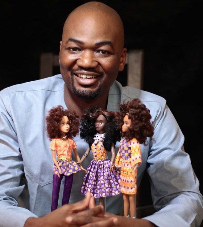 Taofick Okoya poses with the Queens of Africa dolls. 