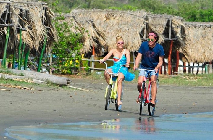 Colombian singers Shakira and Carlos Vives ride bikes during the recording of the video for the song "La Bicicleta."