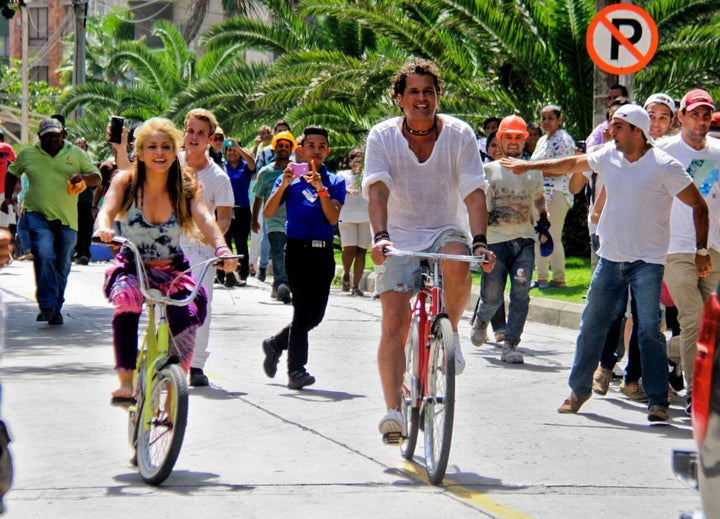 Dozens of fans showed up to watch the two Colombian singers ride their bicycles. 