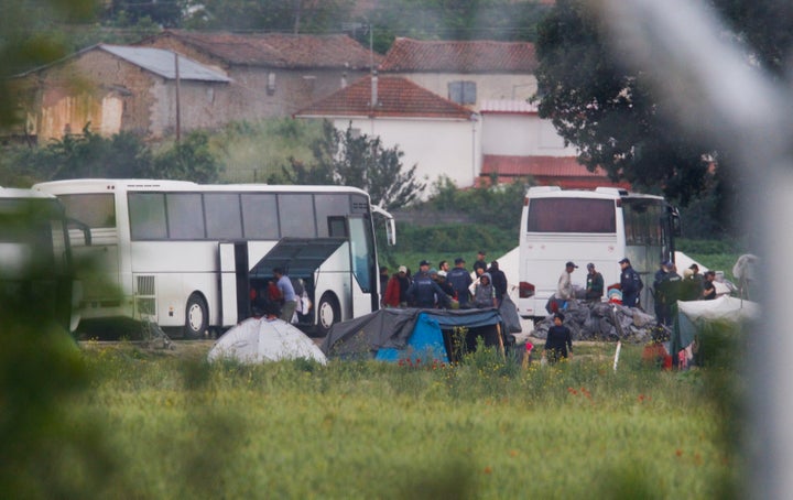 Greek policemen clear a makeshift camp for migrants and refugees at the Greek-Macedonian border.
