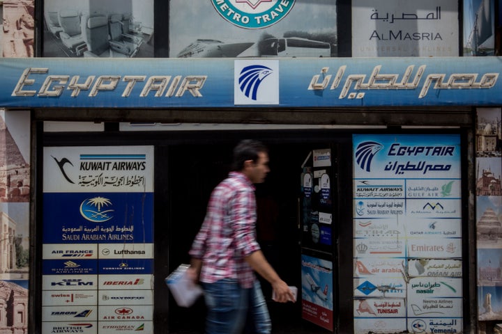 Pedestrians walk past a tour agency promoting flights by EgyptAir on May 23, 2016 in Cairo, Egypt.