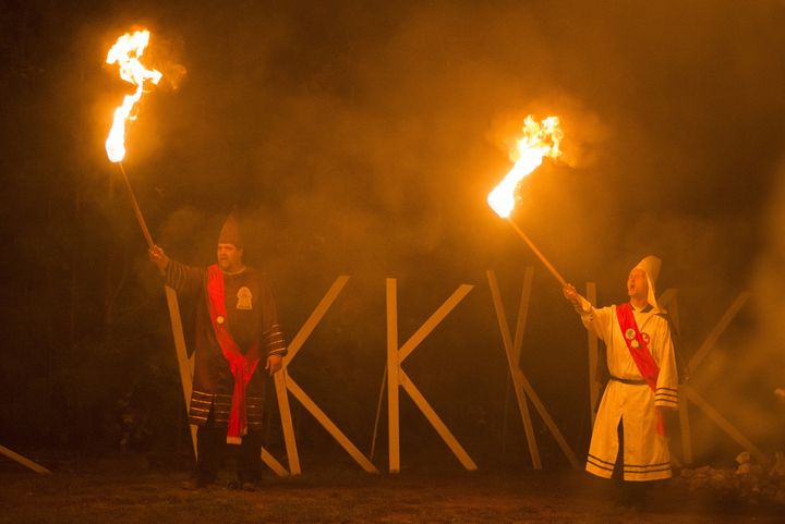 Members of the Rebel Brigade Knights and the Nordic Order Knights, groups that both claim affiliation with the Ku Klux Klan, hold their lit torches during a cross lighting ceremony at a private residence in Henry County, Virginia.