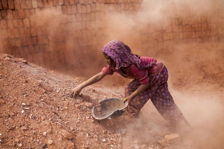 DHAKA, BANGLADESH - FEBRUARY 09 : Child labors collect coal from dust near brick making field in Dhaka, Bangladesh on February 09, 2016. Despite of the hazardous effect of dust on health, child labor collect coal and sell it around $4 per a week to help their family budget. Child labor in Bangladesh is around 30.1%. Bangladesh adopted the National Child Labor Elimination Policy at 2010, providing a framework to eradicate all forms of child labor by 2015, but according to the International Labor Organization there are still around 3.2 million child labors in Bangladesh. (Photo by Zakir Hossain Chowdhury/Anadolu Agency/Getty Images)