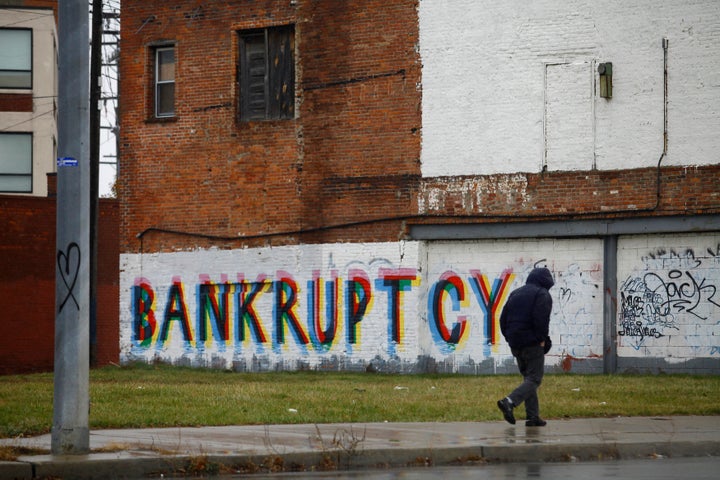 A man walk past graffiti in Detroit on Dec. 3, 2013.