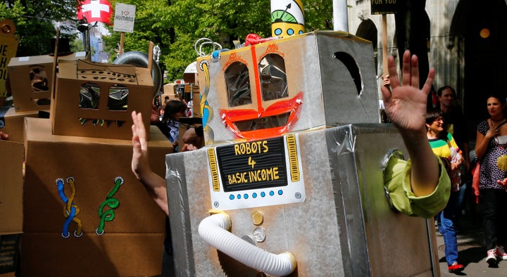 Protesters dressed as robots demand a basic income for everyone during a demonstration at the Bahnhofstrasse in Zurich, Switzerland on April 30, 2016.