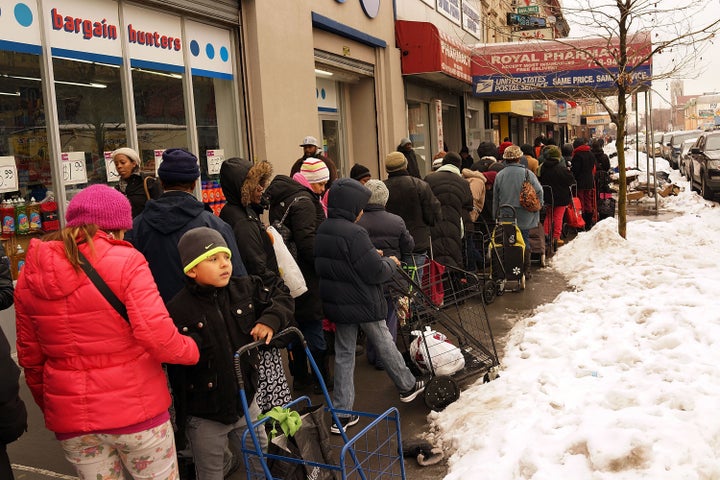 People wait in line at a food pantry in Brooklyn on February 18, 2014. Currently the food pantry sees up to 4,