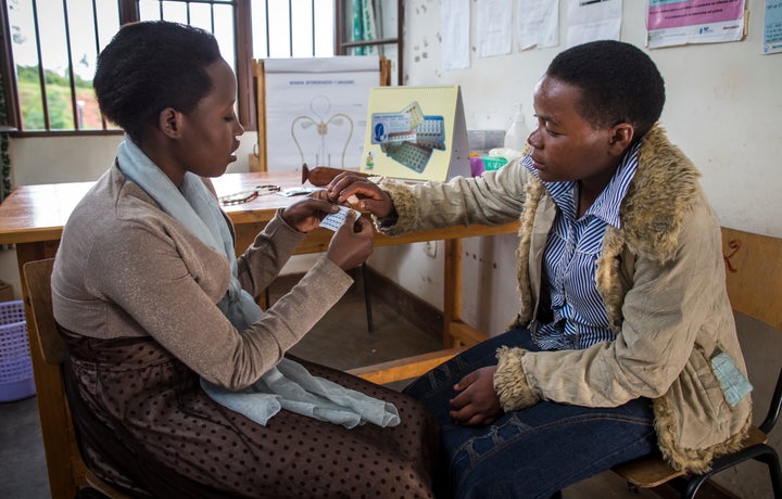 Young women in Uganda discussing the use of different contraceptives.