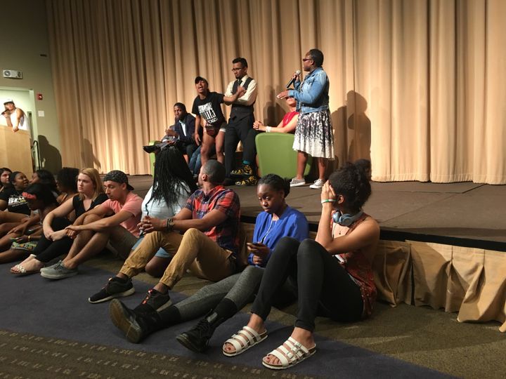 Radical activists check their phones while shutting down a Depaul University event