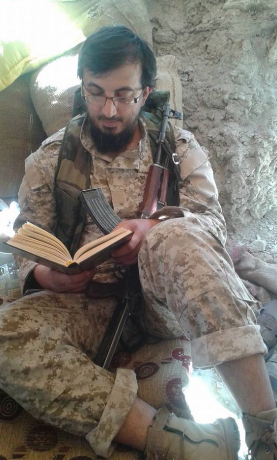 A photo posted on the doctor's page apparently shows him reading the Koran and cradling an automatic rifle.