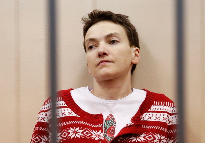 Ukrainian military pilot Nadezhda Savchenko looks out from a defendants' cage as she attends a court hearing in Moscow March
