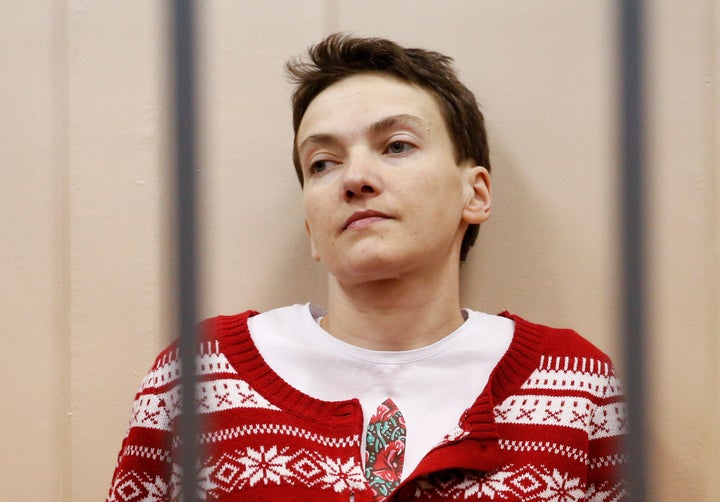 Ukrainian military pilot Nadezhda Savchenko looks out from a defendants' cage as she attends a court hearing in Moscow March 4, 2015.