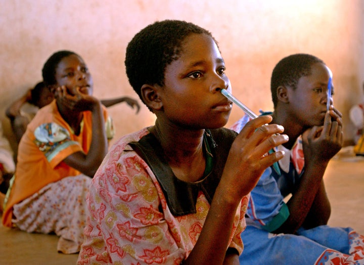 MTEMA NYEMA, MALAWI - JULY 3: Malawian girls listen to their teacher at a rural school July 3, 2002 in the village of Mtema Nyema in the Phalombe District which is east of Blantyre, Malawi. After the droughts and flooding in the last year, half of the students stopped coming to class because of the ongoing food shortage in the region. The World Food Program estimates that 3.2 million people in Malawi alone will be affected before March 2003. (Photo by Ami Vitale/Getty Images)