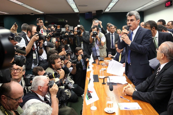 Senator Romero Juca (2nd R) announces his party is withdrawing their support of President Dilma Rousseff's ruling coalit