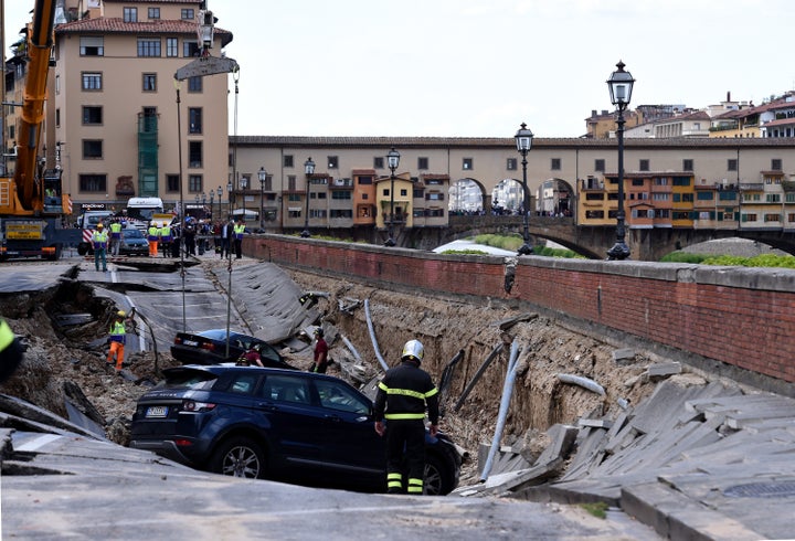 A road in central Florence collapsed on Wednesday, causing some 20 cars to fall into a ditch and cutting off water supply to parts of the city.