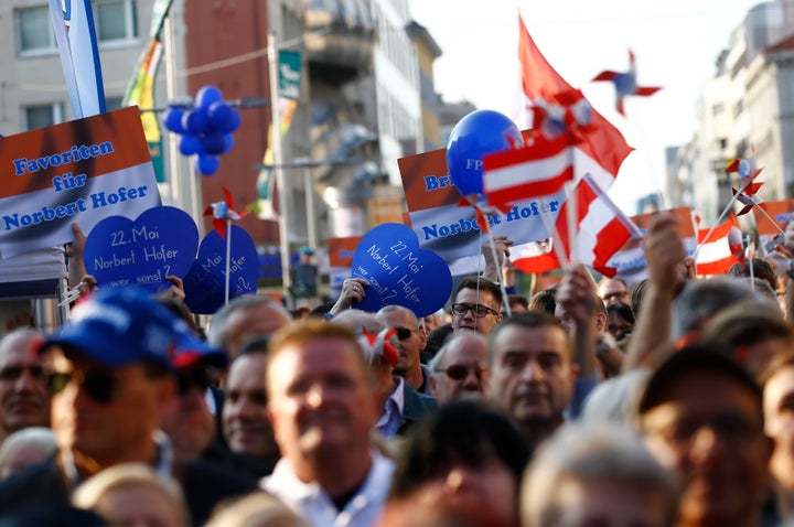 Supporters hold placards and wave flags for Austrian far-right Freedom Party presidential candidate Norbert Hofer. Hofer narrowly lost the Austrian election on Monday.