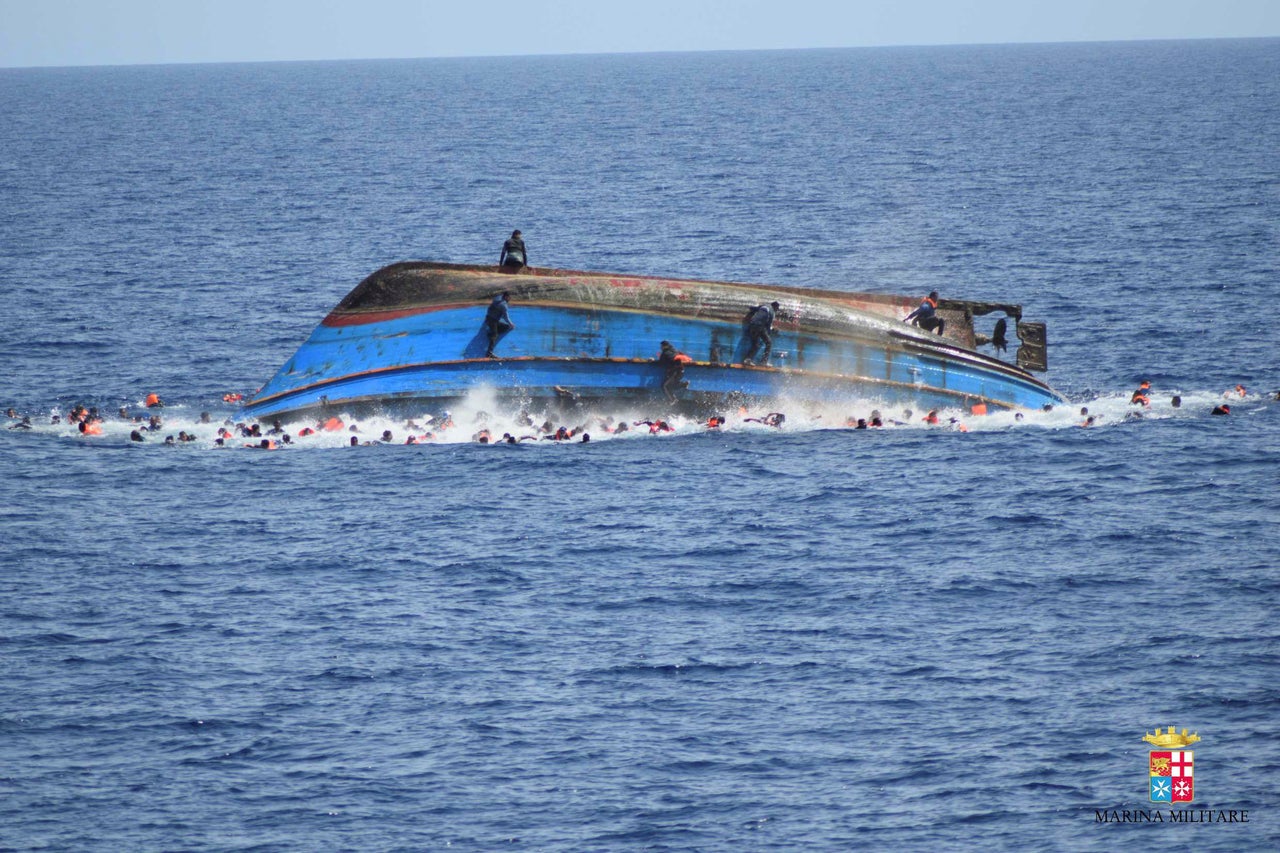 Some migrants later climbed onto the hull of the overturned vessel, while others swam for lifeboats or toward the navy ship