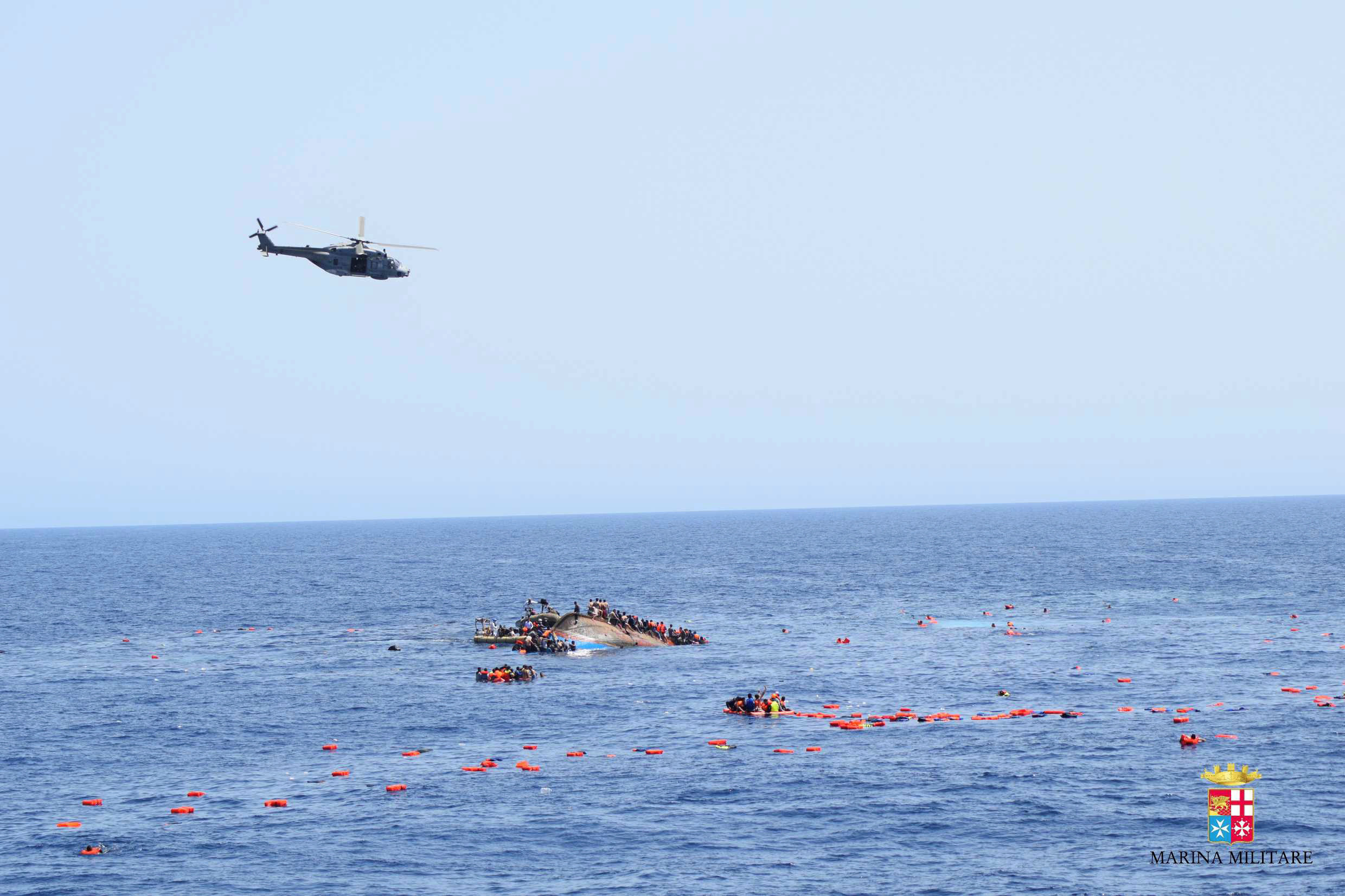 Desperate Migrants Pictured Clinging To Sinking Boat In The ...