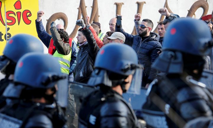 French gendarmes observe striking workers near the oil refinery at Fos-sur-Mer, France, on May 24, 2016.