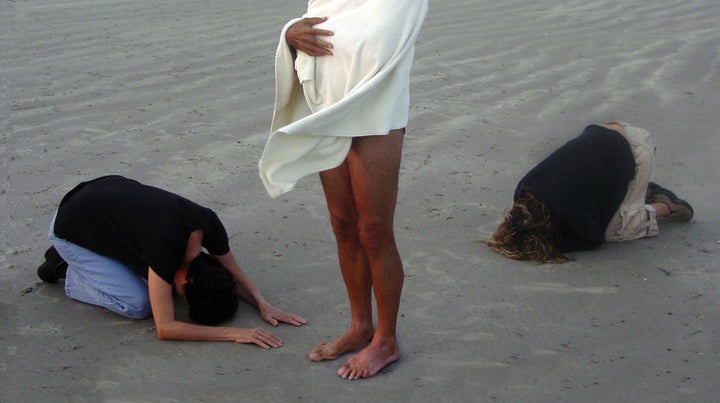 Devotees bow at Michel/Andreas' feet.