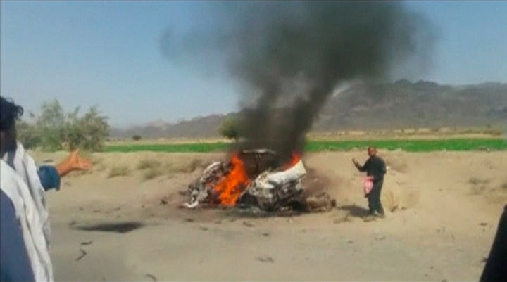 A car is seen on fire at the site of a drone strike believed to have killed Afghan Taliban leader Mullah Akhtar in southwest Pakistan in this still image taken from video, May 21, 2016.