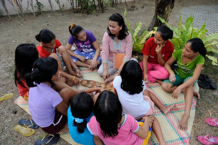 Cecilia (center in pink) in a healing session with trafficking survivors.