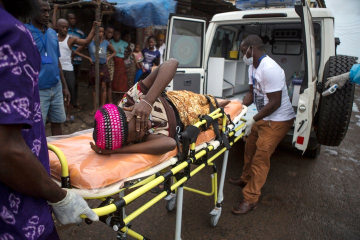 During Sierra Leone’s Ebola crisis, thousands of girls became pregnant. Here, a pregnant woman suspected of contracting Ebola is lifted by stretcher into an ambulance in Freetown, Sierra Leone on September 19, 2014.