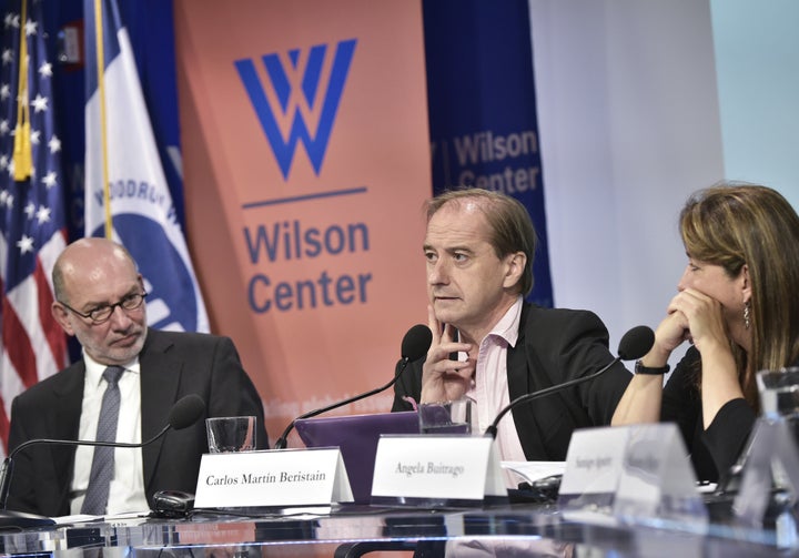 Mexico's Ambassador to Austria Luis Alfonso de Alba (L) and Angela Buitrago (R) of Colombia watch as Carlos Martín Ber