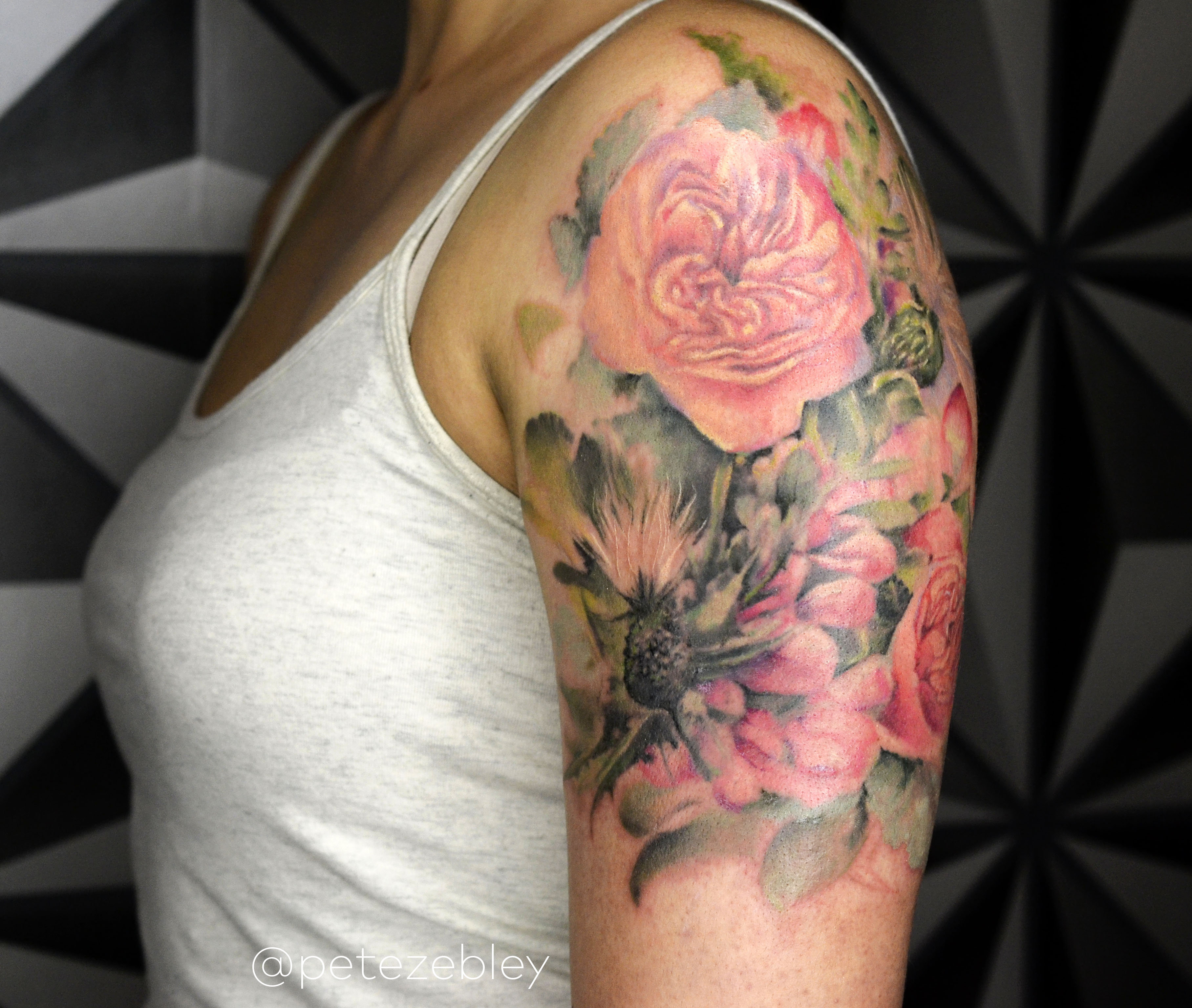 Flower bouquet tattoo located on the bicep