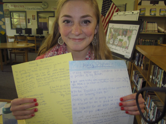 Me at age 16, holding up 'compliment sheets' after my first workshop