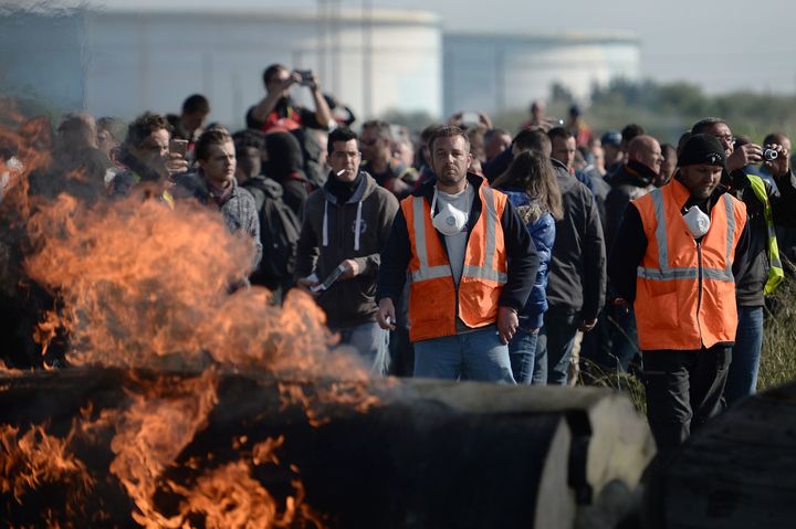 Workers on strike set up a fire barricade near the Total refinery of Donges, western France
