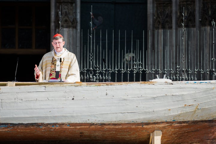 Cardinal and archbishop Rainer Maria Woelki conducts the Corpus Christi Mass from a seven-meter-long refugee boat on May 26, 2016 in front of the cathedral in Cologne.