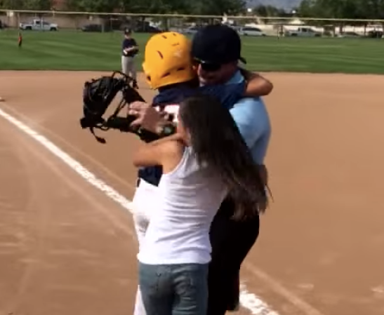 Master Sgt. Randy Brock hugs his overjoyed son and daughter.