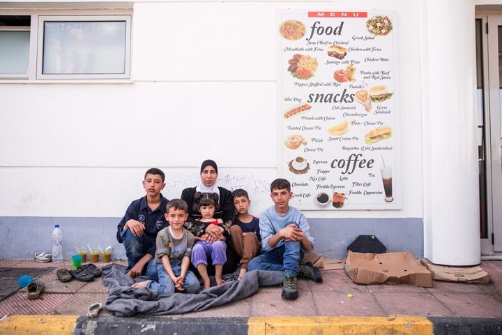 Umm Umran, 41, sits on the pavement with her five children -- Umran,16, Mohammed, 15, Ali, 11, Ala'a, 6, and Adidas, 4 -- outside EKO gas station. The family have lived there since late March, waiting to join their father in Goldenstedt, Germany.
