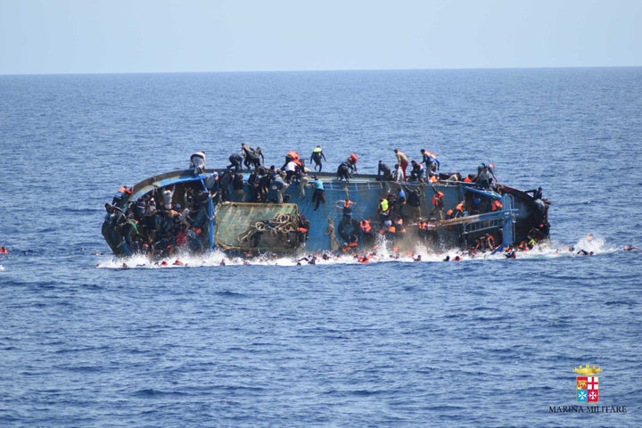 An overcrowded migrant boat shortly before capsizing in the Mediterranean Sea between Libya and Italy on Wednesday. The Italian navy rescued over 500 passengers but several drowned.