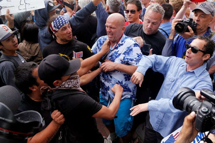 Donald Trump supporters and anti-Trump demonstrators clash outside a campaign event for in San Diego on Friday.