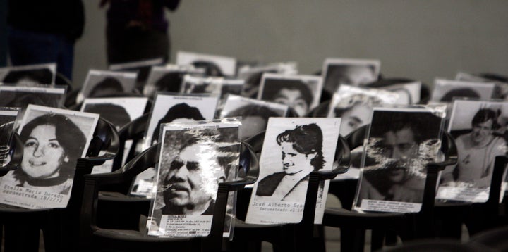 Pictures of those who disappeared during Argentina's 1976-83 military dictatorship are seen placed on chairs during a 2010 trial of Reynaldo Bignone.