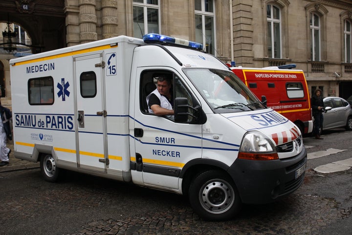 An ambulance leaves a building requisitioned to treat injured people near the site of the accident