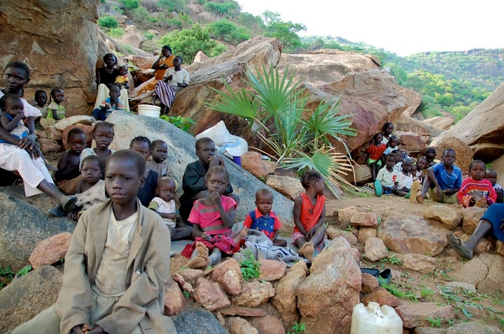 Women and children climb rocky hillsides near Kauda in Sudan's Nuba Mountains to seek cover from government air strikes. Over the past month, Sudan has significantly increased aerial attacks in the rebel-controlled area.