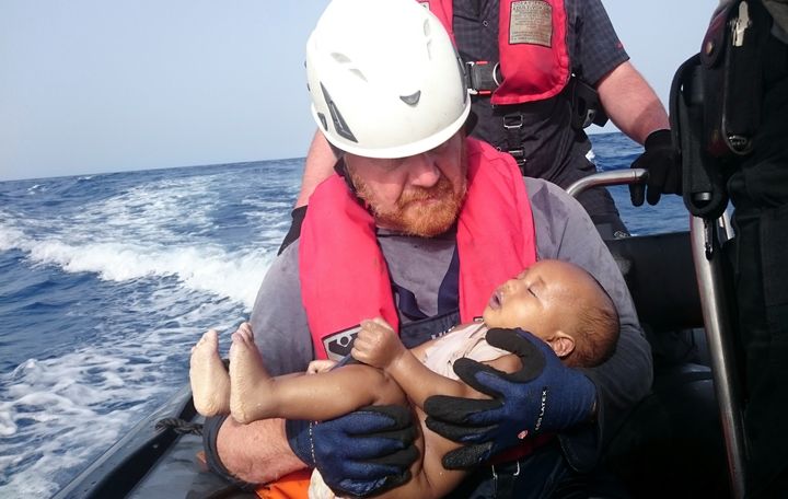 German rescuer from the humanitarian organisation Sea-Watch holds a drowned migrant baby, off the Libyan cost May 27, 2016. The baby, who appears to be no more than a year old, was pulled from the sea after a wooden boat capsized last Friday. (Christian Buettner/Eikon Nord GmbH Germany/Handout via REUTERS)