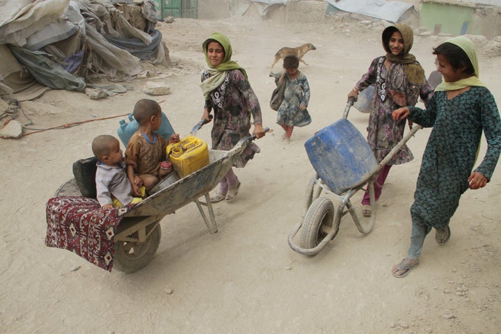 Displaced Afghan families from Helmand province live in a temporary shelter at a refugee camp in Kabul.